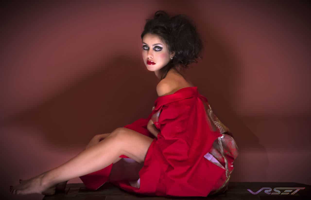 Model photographer in O.C. The blush colored wall accents the blue eyed brunette model wearing this red kimono robe