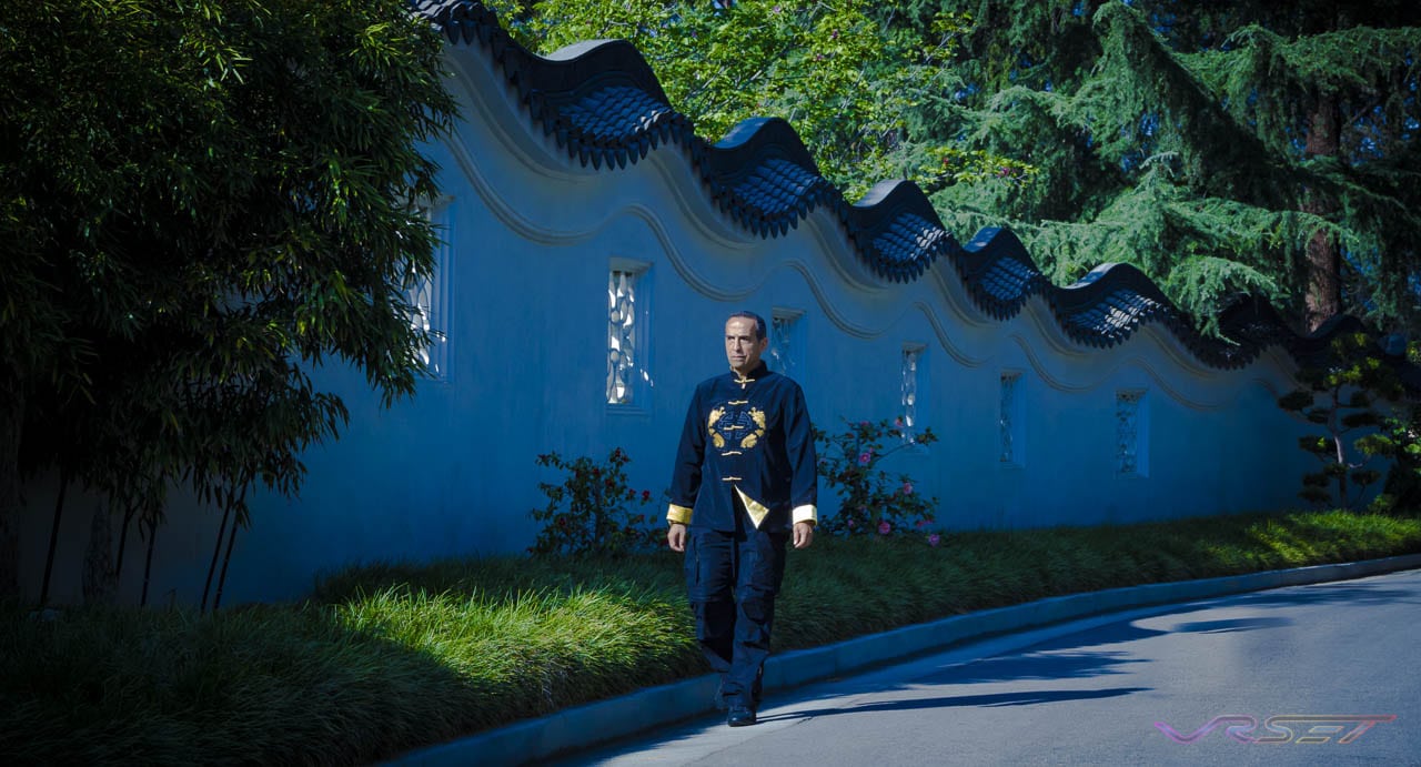 man chinese jacket walking chinese monestary wall