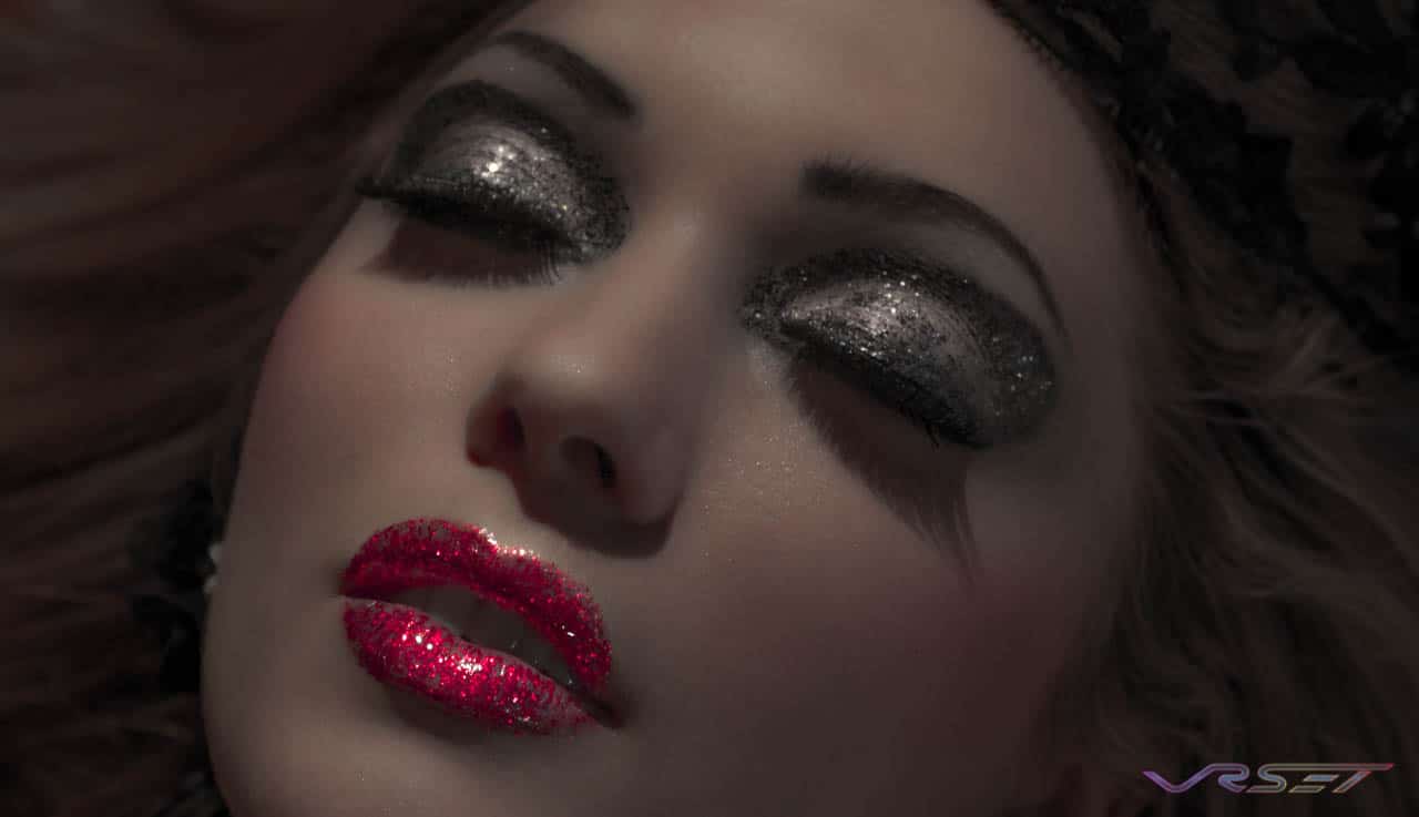 model with glitter glamour makeup headshot dim lighting