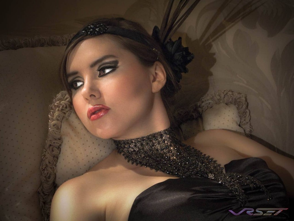 reclining glamor photo female model ornate neck piece