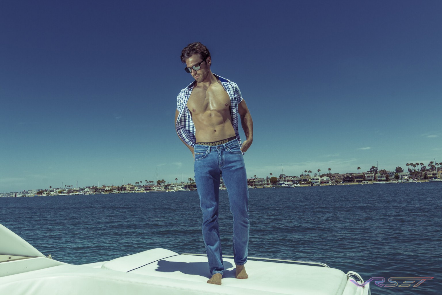 Model Gamzat Lu Blue Plaid Shirt Fitted Jeans Lifestyle Fashion Photography Johnwin Menswear Brand Onboard Yacht OC Coast