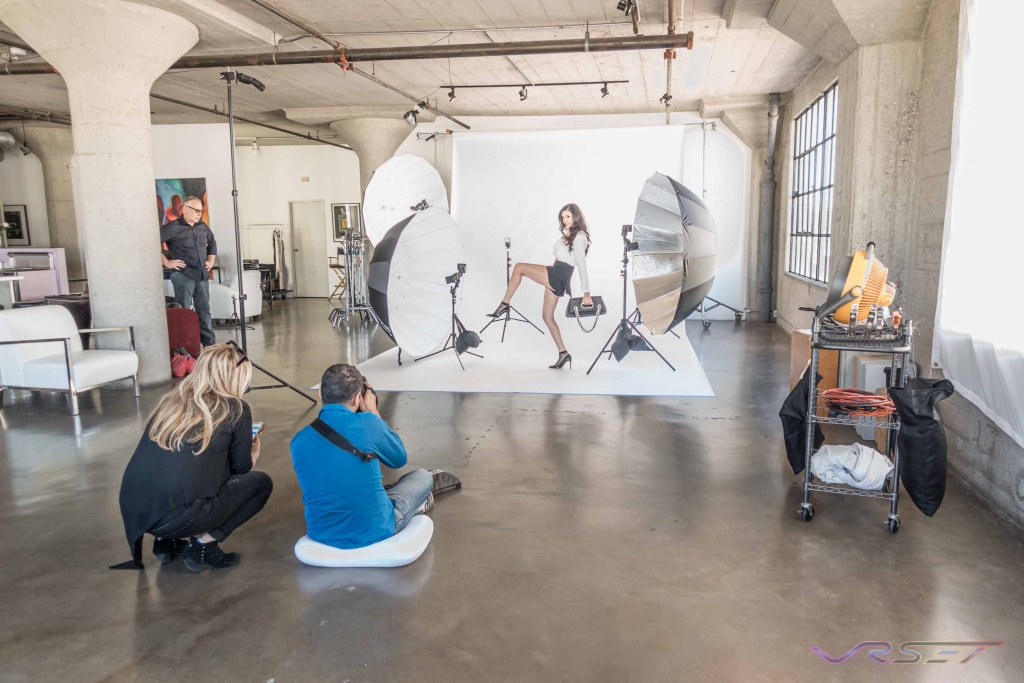 Behind The Scenes Of Crew Lining Up The Camera And Lighting On The Model At A Clothing Photography Studio In La