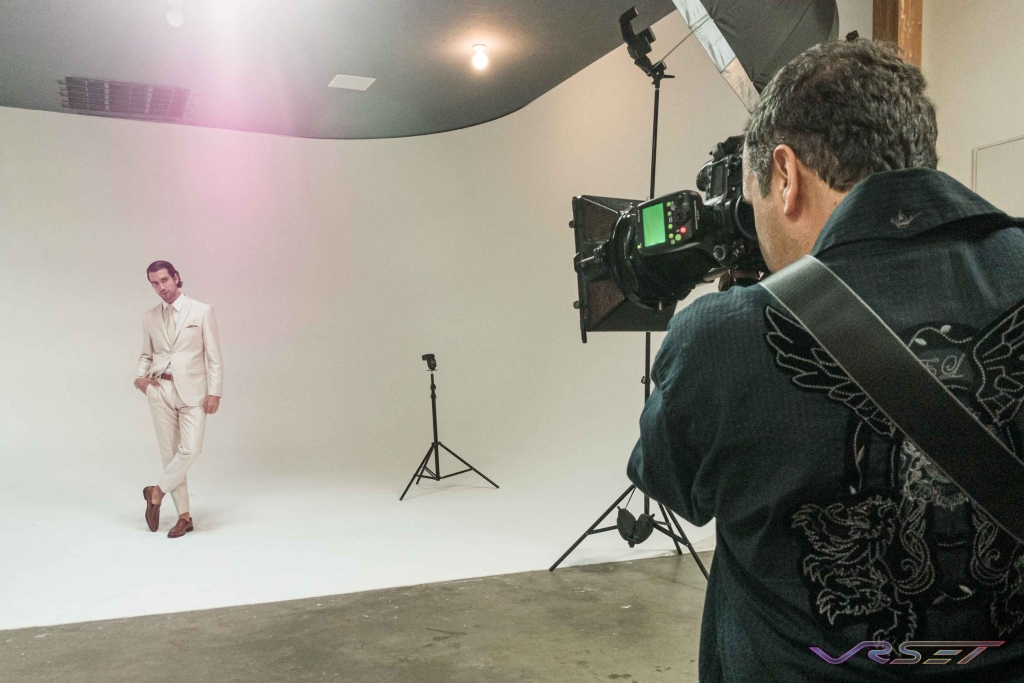 Shooting the model wearing white mens suit at an LA clothing photography studio