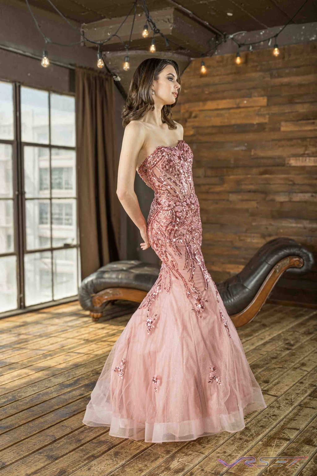 Model in a peach gown with crystal embroidery across the bodice, shot in a studio Model in a peach gown with crystal embroidery across the bodice, shot in a studio